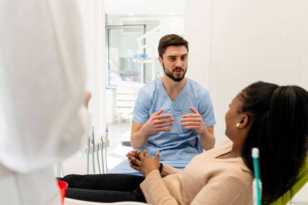 Dental professional speaking with patient, reassuring consultation scene
